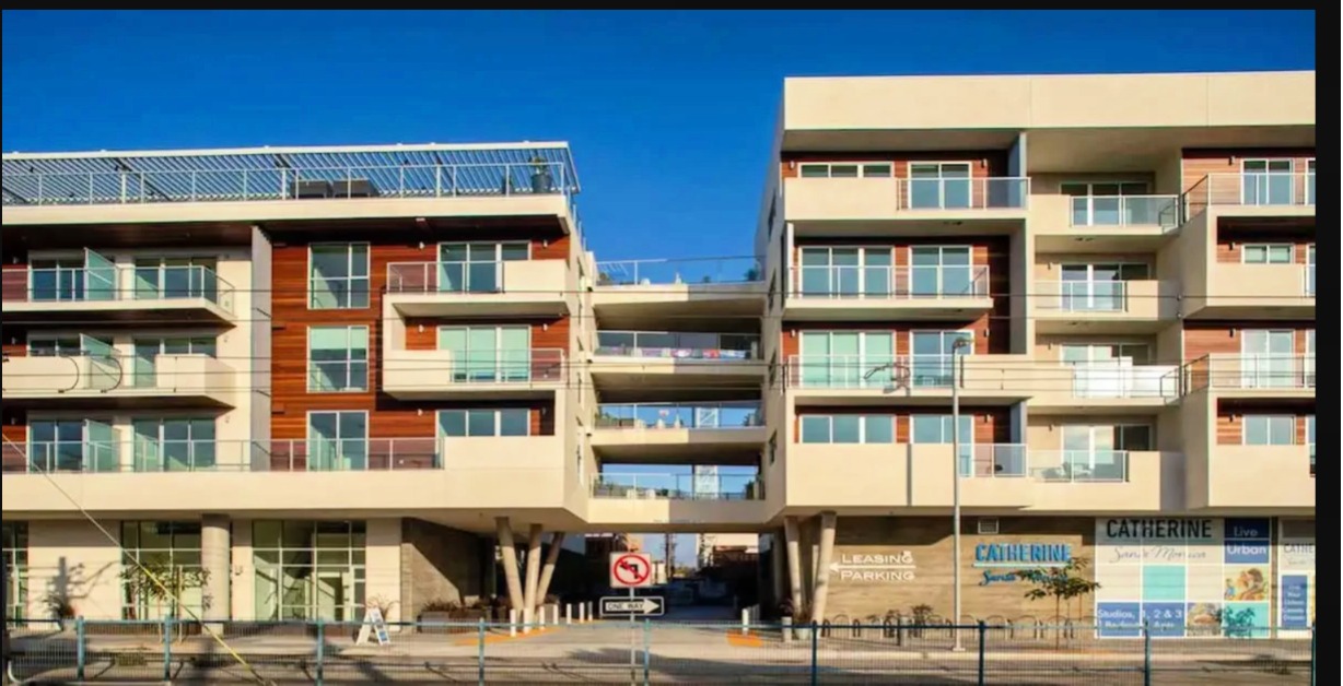 Modern commercial building 'The Catherine' in Santa Monica, Los Angeles, featuring a sleek glass facade and contemporary architectural design.